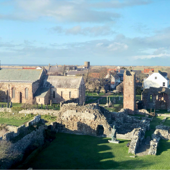 This is ##Holyisland (also known Lindisfarne), an isolated tidal island off the northeast coast of England, in Northumberland
Really quaint island, self contained with lots of nature/ coastal walks, accommodations, abbey, castle, church and restaurants 
Worth an exploration
Check the tide times though 