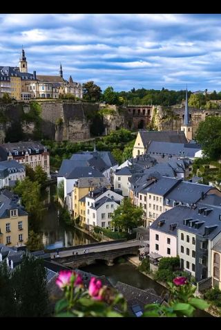 🇱🇺 Fairytale Views at the Grund, Luxembourg City ✨

Stepping into the Grund feels like walking straight into a storybook! Nestled in the valley below the historic cliffside walls of Luxembourg City, this picturesque riverside district is famous for its cobblestone streets, slate-roofed historic houses, and stunning views of the Alzette River.

📍 Spot Details
· Location: Grund (Lower Town), Luxembourg City 🇱🇺
· Key Landmarks in Photos:
· Chemin de la Corniche: Known as "Europe’s Most Beautiful Balcony," offering the best panoramic vantage point looking down into the valley.
· Neimënster (Neumünster Abbey) & St. John's Church: Features the iconic slate-pointed spire visible right along the riverbank.
· Old City Walls & Fortifications: Historic stone towers and arches overlooking the valley.

💡 Tips for Visiting
1. Best Viewpoint: Head to Chemin de la Corniche at golden hour before sunset for the softest light and crisp photos over the valley.
2. Getting Around: Take the free Grund Elevator (Ascenseur St-Esprit) from the Upper Town down into the canyon for instant access without climbing all the stairs.
3. Free Transit: Public transportation (trams, buses, trains) is 100% free across the entire country!

#LuxembourgTravel #Grund #CheminDeLaCorniche #EuropeTravel #TripMoments #FairytaleDestinationss
