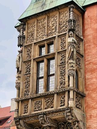 #winterescape Cloudy Nights & Historic Vibes at Środa Śląska’s Ratusz 🌧️🏛️  
Step into the heart of Środa Śląska with its stately Ratusz (Town Hall), a striking red-bricked landmark that blends Western-style architecture with centuries-old tradition. At night, the building’s illuminated façade and statues create a dramatic scene—perfect for moody, rain-kissed photography!

Recommended route: Start your stroll on plac Wolności, where the Ratusz commands the square. Admire the intricate details on the building’s exterior, especially the two statues flanking the entrance. On rainy evenings, the wet cobblestones amplify the red tones and reflect city lights, making it a dreamy spot for your first photo stop.

Must-do: Snap close-ups of the statues and wide-angle shots of the Ratusz against the cloudy sky. Don’t miss peeking indoors—if open, the architectural interiors give a glimpse of Środa Śląska’s civic history. Explore nearby cafes for a warm drink while watching locals pass by the illuminated town hall.

Top insta-worthy angles: Shoot from the corner facing plac Wolności for a dramatic composition; use the puddles after rain to capture cool reflections. Nighttime with moody clouds and glowing windows is a winning combo.

Visiting tips: Bring a waterproof jacket and camera lens protection—rain here is frequent and adds to the ambiance! Early evening is best for balanced light and fewer crowds. Most indoor sections are open during regular office hours (8:00–16:00) and closed on weekends.

Precautions: Watch for slippery surfaces after rain and respect any barriers around the statues or entrance.

#Poland #SrodaSlaska #Architecture #NightPhotography #TravelTips