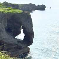 Cape Manzamo: Okinawa’s Dramatic Cliffside Wonder – A Solo Traveler’s Coastal Escape"** 🌊🗿