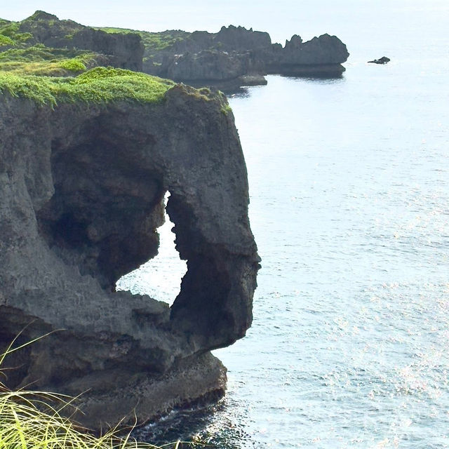 Cape Manzamo: Okinawa’s Dramatic Cliffside Wonder – A Solo Traveler’s Coastal Escape"** 🌊🗿