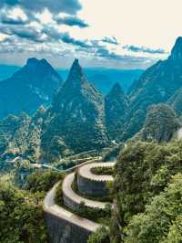 Rising like silent sentinels from the mist, the stone pillars of Zhangjiajie stand timeless and sere