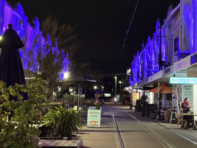 Artist city w colorful lights illuminating old buildings 