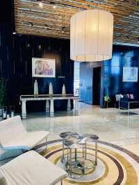 “Elegance in Motion: The Grand Lobby and Iconic Spiral Staircase of Hotel Maya KL”