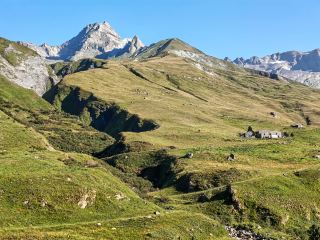 Walked to Italy today. Literally. Started the morning at the Mottets cabin in France and ended up taking a cab into Courmayeur. 

Crossing the border at Col de la Seigne was easily the coolest part of the TMB so far. One minute you're walking through polite, green French valleys, and the next you cross this ridge at 2,500m and Italy just hits you in the face. It’s all jagged, wild black peaks and the massive south face of Mont Blanc looking very dramatic. 

Stopped by Rifugio Elisabetta which is basically perched right under a glacier. Quite fancy staying there next time, the views are ridiculous. Further down the trail, there's this spot where two glacier rivers meet—one is totally muddy and grey, and the other is crystal clear. Looked a bit like a badly poured pint, but still neat to see. 

Ended up clocking about 15km and my knees are absolutely knackered after the 900m descent. My cheap, beat-up trail runners survived another day though, despite my flatmate telling me I needed £200 boots for this. Currently in Courmayeur waiting for a massive bowl of pasta.