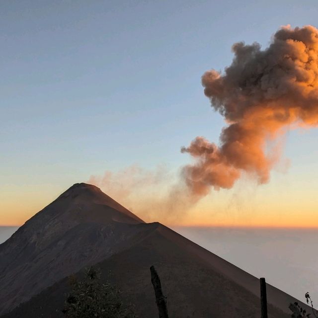 Sunset behind an erupting volcano