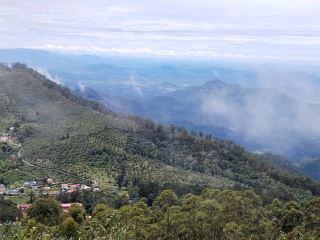 🌄 Kodaikanal Hill Station: Where Misty Lakes Meet Mountain Magic! 🏞️✨  
Wake up to dreamy clouds, shimmering lakes, and a cozy little town wrapped in the embrace of lush mountains—Kodaikanal is the South Indian hill retreat that’s pure serenity mixed with nature’s spectacle.

Kick off your visit with a morning stroll by Kodaikanal Lake. Rent a rowboat for a tranquil glide or cycle the lakeside path, soaking up fantastic overlooking views—especially magical when mist softens the forested edges. Wander into town for fresh local eats, chai breaks, and glimpses of modern architecture tucked among the trees. The clouds and fog add a mysterious touch—perfect for “nature-vision” snaps. For panoramic shots, trek up to Coaker’s Walk or Bryant Park: early mornings offer especially insta-worthy angles when sunlight streams through the mist. 

If you love outdoor scenery, don’t miss the chance to hike to Pillar Rocks or Dolphin’s Nose, passing waterfalls and rain-kissed forests that shimmer on sunny days or turn otherworldly in the rain. Your image of a small town by a lake is spot-on—try the viewpoint behind Kodaikanal Lake for that exact “mountains-meet-modern” photo!

Visiting tips: Kodaikanal is open year-round, but its mood shifts with the weather—carry a raincoat for sudden showers and walk carefully on misty, slippery paths. Pack layers (nights can get chilly), and if you’re here in summer, be sure to start hikes early before the crowds and clouds roll in.

#Kodaikanal #HillStation #NatureEscape #MountainMagic #IndiaTravel