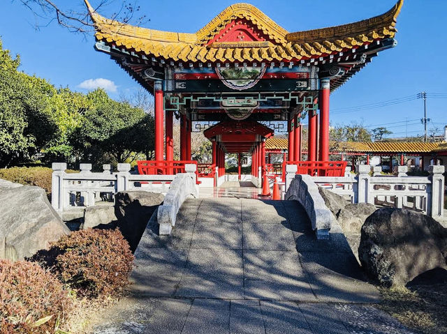 Spacious park with seasonal flowers and a peaceful pond,
