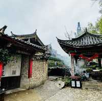Quaint stone village under Yulong Mountains