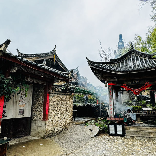 Quaint stone village under Yulong Mountains