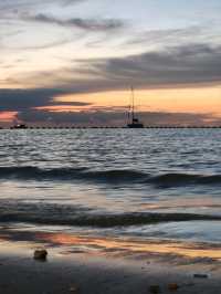 "A white sandy beach with clear water, perfect for swimming and spending the whole day in the water.
