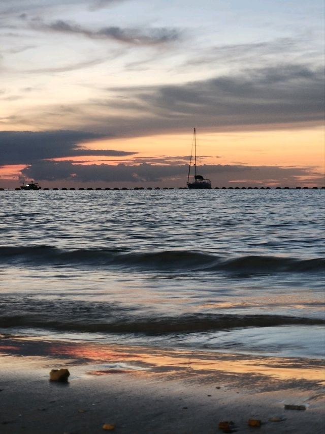 "A white sandy beach with clear water, perfect for swimming and spending the whole day in the water.