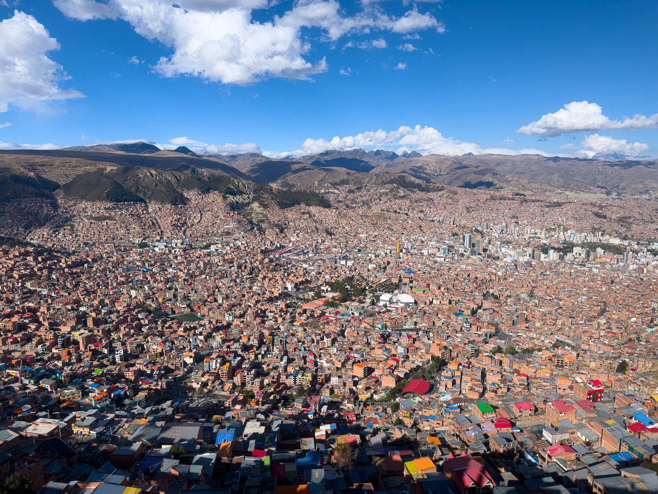 Glide over La Paz, gazing down into the bowl-like city and the snow-capped mountains beyond