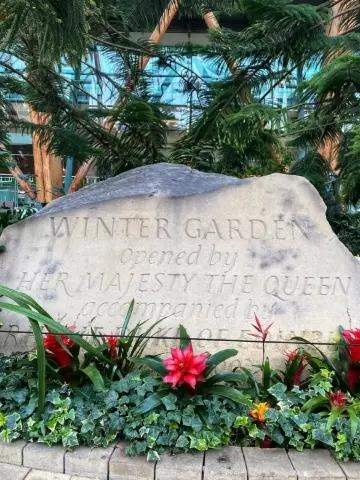 The selection of tropical flowers and plants are housed under the incredible structure above.