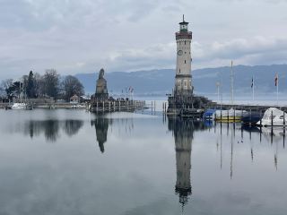 Lindau, located in southwestern Bavaria, Germany, sits on the eastern shore of Lake Constance, bordering Austria and Switzerland. With a population of approximately 26,000, it is one of Germany's most famous lakeside cities. Its historic old town, built on a small island in the lake and connected to the mainland by bridges and railways, is known as the "Pearl of Lake Constance." Lindau was first mentioned in 9th-century documents and became a free city of the Holy Roman Empire in 1275, flourishing thanks to its lakeside shipping and trade. The port entrance features a 36-meter-high lighthouse and a statue of the Bavarian Lion, forming the city's most iconic landmark. The old town preserves numerous medieval and Renaissance buildings, among which the Old Town Hall is famous for its exquisite painted facade, and the Manger Tower is a 13th-century defensive tower. The annual Lindau Nobel Laureate Meetings attract scientists from around the world, giving this historic city both profound cultural heritage and international influence.
