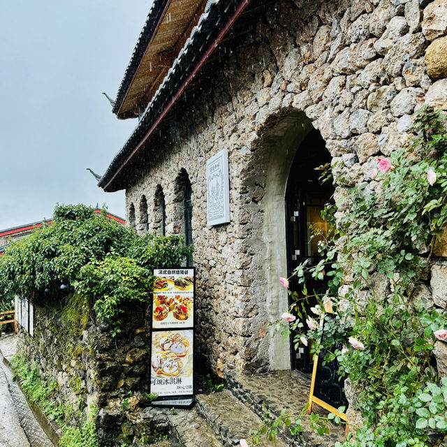Quaint stone village under Yulong Mountains
