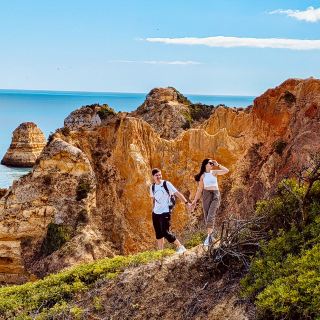 🌊 Coastal Wonders Await at Lagos’ Ponta da Piedade Trail 🌞

If you crave sun-drenched cliffs, sapphire waters, and outdoor adventure, the Ponta da Piedade hiking trail is your perfect Lagos escape! Start your journey at Praia dos Estudantes and head west - the wooden boardwalks make for an easy stroll, but for those jaw-dropping Nature-Vision moments, veer off and climb the rocky outcrops for panoramic shots of the sculpted coastline and hidden coves. 📸 Top photo angles: Cliff edges overlooking the sea, views through natural arches, and any dramatic canyon-like formations.

Look out for tiny secret beaches tucked between the cliffs - ideal spots for a sun-kissed break! About halfway, pause at O Camilo restaurant for a scenic lunch with epic ocean views (yes, it's worth the detour!).

Continue onward and take your time, since the open-all-day route is made for full-day explorations - just bring sunscreen, water, and sturdy shoes for those off-path moments. At the end of the trail, reward yourself with authentic Portuguese cuisine at either O Antonio or Campimar.

Insider tips: Boardwalks help you move quicker if you’re short on time, but best views require a bit of scrambling, so pack accordingly. The area is sunny and exposed; don’t forget sun protection! Rest stops are dotted along the route for those in need of shade.

#falladventures #Lagos #CoastalHiking #NatureVision #Portugal #ScenicViews  