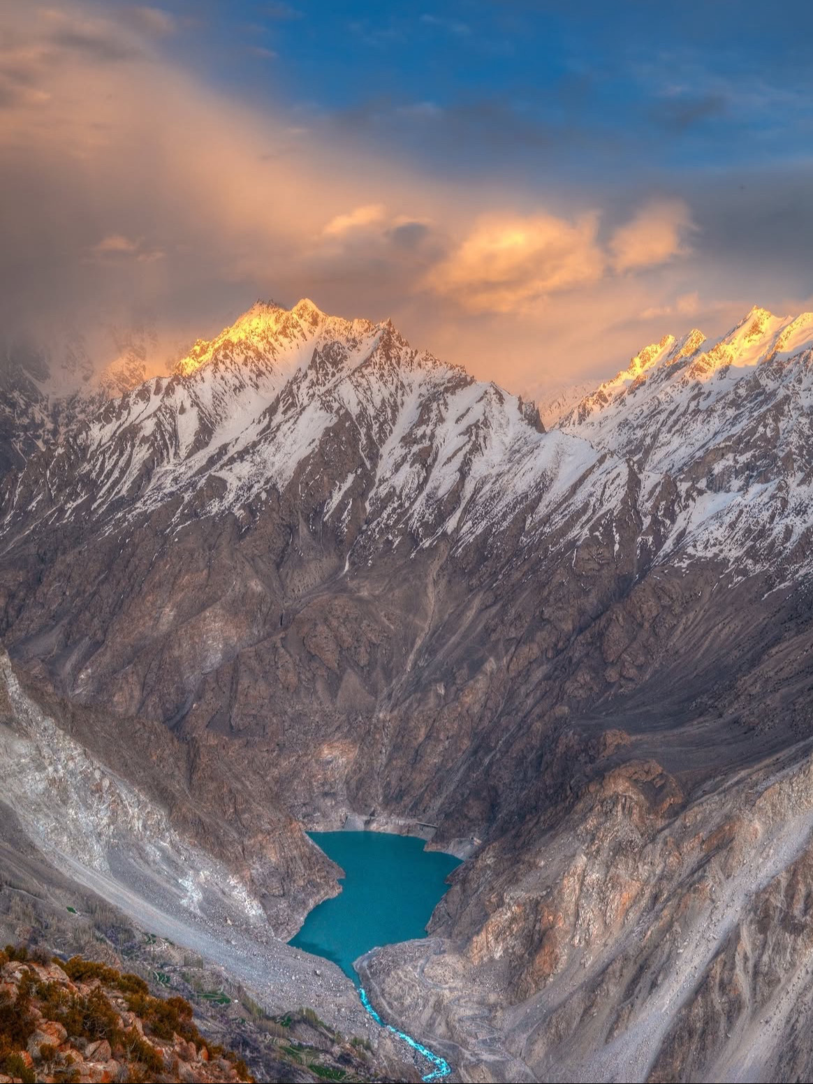 🏔️ Attabad Lake

Attabad Lake is one of the most spectacular sights in Hunza Valley, Gilgit-Baltistan. Its brilliant turquoise-blue water, surrounded by towering Karakoram mountains, creates an unforgettable alpine landscape.

The lake was formed in 2010 after a massive landslide blocked the Hunza River. Today, visitors can enjoy boating, kayaking, and scenic views along the lake.

Beyond Attabad, Hunza Valley offers an incredible mix of snow-capped peaks, ancient forts, apricot orchards, traditional villages, and dramatic mountain roads. Highlights include Passu Cones, Hussaini Bridge, Altit Fort, Baltit Fort, and Khunjerab Pass.

🍂 Best time: April–October; autumn is especially beautiful when the valley turns golden and orange.
