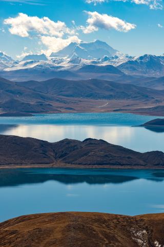 Entering a magical realm on a clear winter day, Yamdrok Lake's jade green hides profound secrets