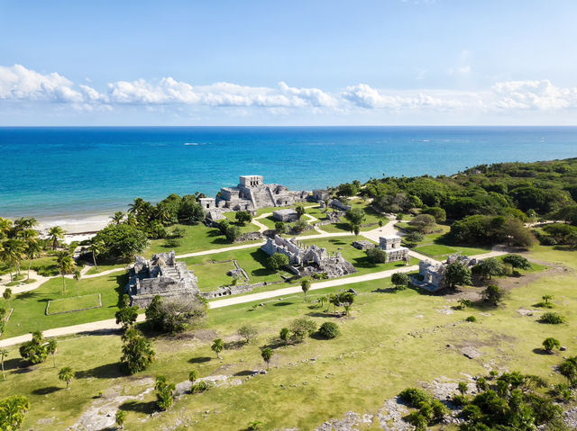 Ruins next to white sand beach 