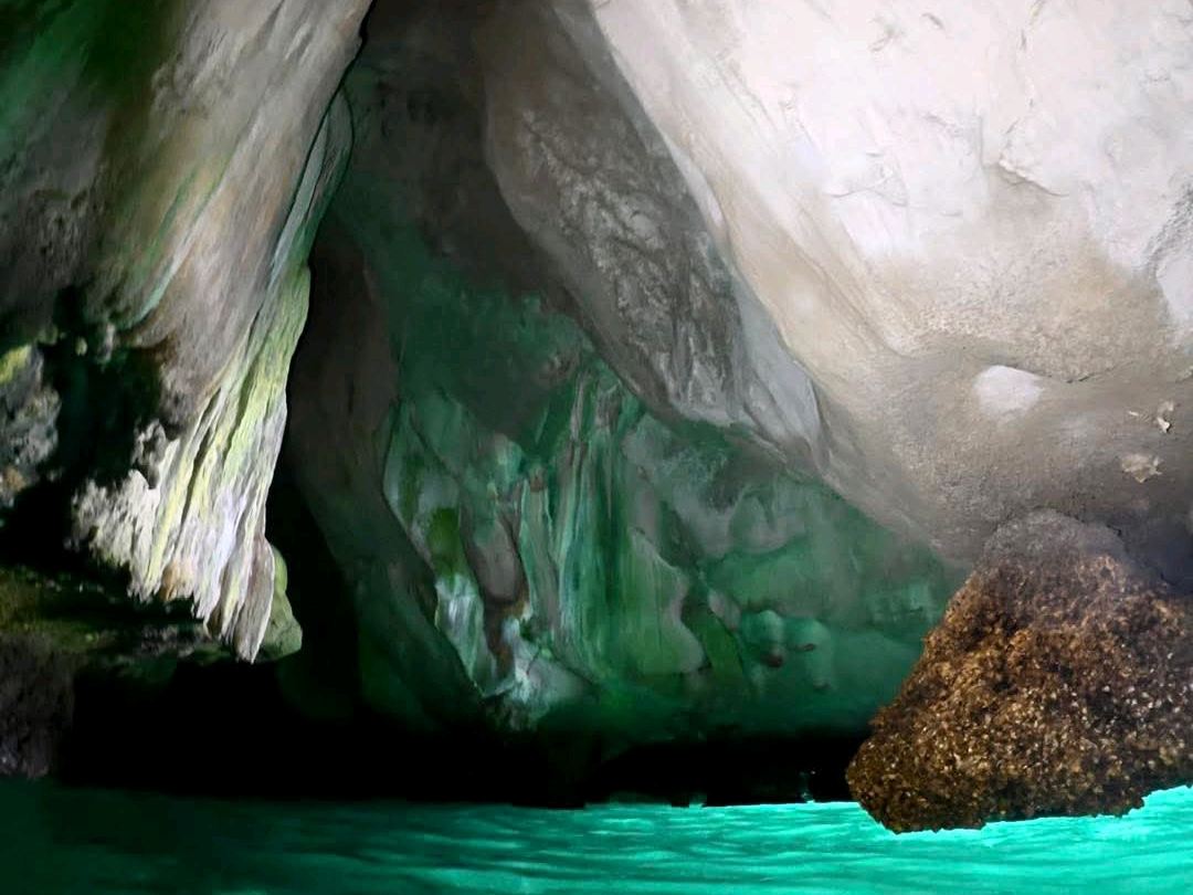 Swim through a cave to discover an emerald sea An 