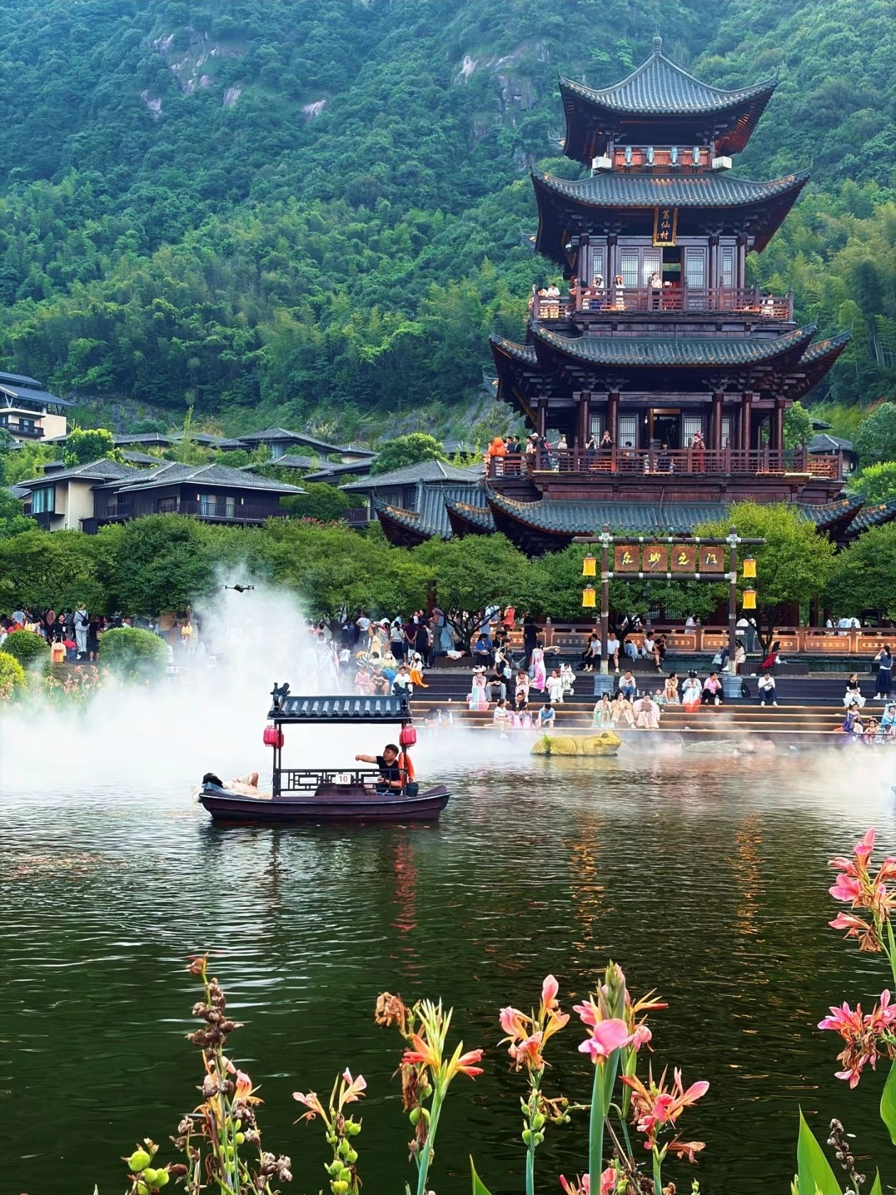 Gexiangcun: A Mountain Resort in Jiangxi Worth Seeing at Least Once

If you think Jiangxi only has Wuyuan and Sanqingshan, you might be missing out on a truly mind-blowing place. It's located in a deep mountain gorge in Qianshan County, Shangrao City, at the foot of the Taoist Gexiangshan Mountain. By day, it's an ancient village in the style of Jiangnan water towns, with black-and-white walls. At night, thousands of lanterns are lit, sky lanterns rise into the sky, and fireworks explode over ancient towers—it's hard to believe there are still places in China with such a vibrant nighttime atmosphere.

💫What is this place?

Gexiancun is not a real ancient village, but a large immersive resort based on the legend of the Taoist monk Ge Xuan, who practiced and achieved immortality in the Gexianshan Mountains. The mountain itself remains immensely popular; locals often say, "Come here once, and you'll come back three years in a row." The resort is built at the foot of the mountain and combines Taoist culture, the landscapes of the Jiangnan mountains and waters, and Han-Tang architecture. Water, bamboo, and the village are key elements.

The scale is considerable. The nightly program officially launched on May 1, 2020, featuring six activities: strolling along the "immortal street," traveling through "immortal lands," admiring "immortal landscapes," enjoying "immortal music," tasting "immortal food," and staying in "immortal chambers." Simply put, you can put on a hanfu, stroll through the park with a lantern, watch a water show, listen to interactive performances, and stay in a mountain guesthouse for a day or two, living the life of a "happy immortal."

🚄🚌🚕How to get there

The high-speed train is the most convenient option. Get off at Shangrao Station. Near the station, at the East Bus Station, there's a special bus to the park. The journey takes about 1.5 hours. Tickets are 30 yuan, with departures every half hour. You can also arrange a shared ride for about 40 yuan per person. By car, enter "Gexiancun Resort Area" into your GPS; there's ample outdoor parking. By plane, the nearest airport is Sanqingshan Airport. After arriving, you can take a taxi to the park or first go to Shangrao City and then take a bus.

Inside the park, take a free shuttle, which takes about 6-7 minutes to the main area, then walk.

☀️What to do during the day

First, stroll along Lingbao Xianjie Street. The stone path is lined with old-style stalls and teahouses, creating a relaxed atmosphere. At Gexian Mingyuan Tea House, terraced tea mountains soar upward, and mist billows at the dust-washing gate—perfect spots for "heavenly" photos. You can take a boat ride on the lake, and throw food—koi will gather in the shape of a bagua sign.

The main attraction is the mountain. Take the cable car up Gexianshan Mountain; a round-trip ticket costs 120 yuan, and the climb takes just over ten minutes. At the Mirror Deck, after the rain, you can see a sea of ​​clouds swirling—a stunning sight. Then head to Gexiancun Palace to pray; there's a wealth of incense there.

If you're not in a rush, spring and autumn are the most pleasant times. In spring, azaleas paint the slopes red, and the tea mountains are freshly green; in late summer and early autumn, after rain, there's a high chance of a sea of ​​clouds.

🌌Night is the soul of the place

Gexiancun is truly memorable after dark.

Around 7:30 PM, the light show on Zhongmiao Tower begins. This 26-meter-tall, all-wood tower in the Han Tang style is the symbol of the entire village. Lasers illuminate it, the entire tower shimmering with color, and the lake reflects the entire tower—the line between reality and illusion blurs. Immediately after, a water-based film, "Return to Truth," is shown on the lake, telling the legend of the Taoist practitioner Ge Xuan, complete with water mist and fire effects—a truly spectacular performance. Both the light show and the water film are included in the main ticket; there's no extra charge.

Next comes a fire pot show (an intangible cultural heritage), a powerful visual experience: dancers twirl flames, sparks flying everywhere. On weekends, there's also a parade of fish-shaped lanterns through the streets and alleys.

The most touching event is the launch of sky lanterns. Every evening in Xingchen Square, thousands of warm yellow sky lanterns rise simultaneously into the sky, accompanied by exploding fireworks—the lights, the lanterns' shadows, and the ancient architecture all overlap. As one tourist put it, "It was all worth it at that moment."

🎟️🕐Tickets and Performance Schedules

A basic adult ticket costs 130 RMB, though you can sometimes find it for 90 RMB per person when booking online in advance. This includes a sightseeing shuttle and the night parade. A combination ticket (entrance + round-trip cable car) costs 230 RMB—the best value. If you only want the night program, an evening ticket after 7:00 PM costs 60-80 RMB.

Children under 1.2 meters tall and seniors over 70 are free; students and seniors aged 60-69 are half price.

❗❗❗Please note: Some performances may not operate on Tuesdays. Be sure to check the park's schedule before your visit. For the light show, we recommend securing a spot by the lake 20 minutes before the show starts, as it can get very crowded on holidays.

🏠🍛What to eat and where to stay

Qianshan braised rice noodles are a must-try: the broth is made from pork bones, slippery and spicy, with local pickled vegetables—one bowl is warm and filling. These lantern-shaped noodles resemble small oil lamps, their glutinous rice husks stuffed with radish, bamboo shoots, mushrooms, and fresh meat. They're crispy on the outside and soft on the inside. Tianyuan Restaurant on Lingbao Xianjie Street serves Jiangxi dishes: braised pork with dried bamboo shoots and seasonal river fish—around 50 yuan per person.

Accommodation options are available. For convenience, the Zhenshansu Hotel in the park offers excellent value for money, with mountain views from the window and a short walk to Zhongmiao Tower, many packages include tickets and breakfast. The Xixin Yuan and Yueran Xianju hotels offer a touch of Zen luxury, with some rooms offering private hot springs for ultimate relaxation. For a more budget-friendly option, head to the Gexian Yuan guesthouse village at the foot of the mountain. Locals manage the village themselves, and you can spend a night for just over 100 yuan, just a ten-minute drive away. Over the years, Gexian Yuan has transformed from a migrant settlement into a village with 69 guesthouses; during the high season, weekly revenue can reach over 20,000 yuan.

📌A Few Practical Tips

Wear comfortable shoes. The village is built on a slope, with many steps and climbs. In summer, the mountains are teeming with mosquitoes, so bring insect repellent and sunscreen. During nighttime performances, the lighting is dim and crowds are dense—stay close with children. If you want to capture empty landscapes without people, go early in the morning: in the morning fog, there are few tourists, and it's a completely different Gexiangcun.