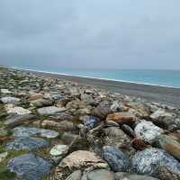 Escape to the pristine shores of Qixingtan Beach, where the mountains kiss the ocean