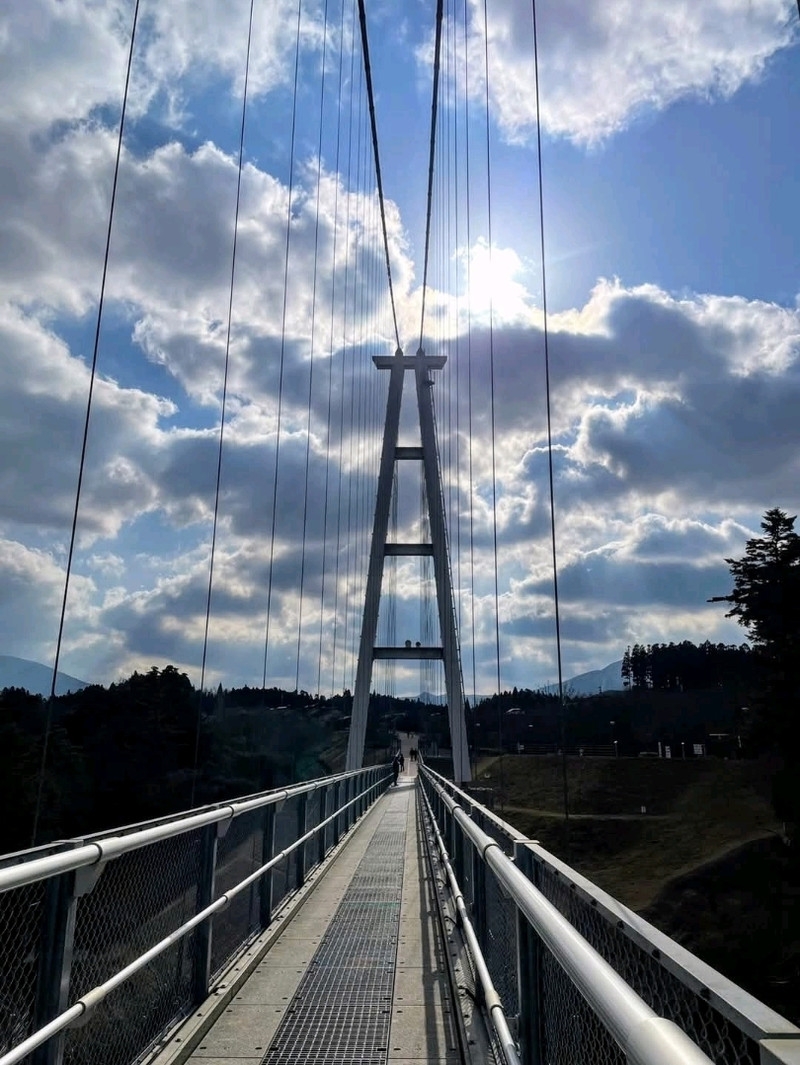 The towering Kujuu Yume Bridge overlooks the Naruko River Valley Waterfall