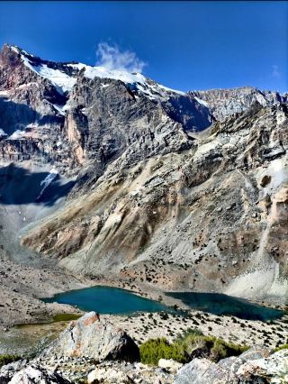 Fann Mountains, Tajikistan 🇹🇯🏔️

One of Central Asia’s most spectacular mountain escapes

The Fann Mountains (Fan Mountains) are a breathtaking mountain range in western Tajikistan, part of the Pamir-Alay system. They’re known for towering jagged peaks, turquoise alpine lakes, dramatic gorges, green valleys, and remote mountain villages.

Unlike some of the better-known Himalayan destinations, the Fann Mountains remain relatively quiet, making them especially appealing for travelers looking for raw nature and off-the-beaten-path adventures.

🏔️ The landscape

The Fann Mountains rise dramatically from valleys, with numerous peaks reaching 4,000–5,000+ meters. The contrast is incredible: enormous rocky mountains rise above lush green valleys and intensely blue mountain lakes.

One of the most famous peaks is Chimtarga Peak (5,489 m), the highest summit in the Fann Mountains. It’s a serious mountaineering objective, but you don’t need to climb it to experience the spectacular scenery.

💎 Famous lakes

Iskanderkul Lake 🌊
One of Tajikistan’s most famous natural attractions. The large turquoise lake sits at roughly 2,200 m and is surrounded by steep mountains. The name is traditionally associated with Alexander the Great.

Seven Lakes — Haft Kul 💙
A series of seven alpine lakes in the Shing Valley. Each lake has a slightly different character and color, ranging from deep blue to emerald green. The road through the valley provides incredible viewpoints.

Kulikalon Lakes 🏔️
A collection of high-altitude lakes surrounded by dramatic peaks. The area is particularly popular with trekkers and photographers.

Alaudin Lakes 🩵
Known for their striking blue-green water and spectacular mountain backdrop. They are an important stop on several trekking routes.

🥾 Trekking

The Fann Mountains are famous for multi-day trekking. Popular routes connect places such as:

Artuch → Kulikalon → Alauddin Lakes → Mutnyi Lake

Depending on the route and altitude, hikes can involve steep climbs, rocky trails, mountain passes and camping at high elevations.

You can also find local guides, mule/horse support and trekking camps in some areas, which can make longer routes much easier.

🏡 Mountain villages

The journey isn’t only about the mountains. Small villages scattered through the valleys offer a glimpse of traditional Tajik life—simple homes, agricultural fields, fruit trees, livestock and welcoming local communities.

The Panjrud and Seven Lakes region is particularly interesting for combining mountain scenery with village life.

🚙 Getting there

Most travelers approach the Fann Mountains from Dushanbe, Tajikistan’s capital.

A typical journey is:

Dushanbe → Panjakent → Fann Mountains

For places such as Seven Lakes and remote trekking trailheads, a 4×4 vehicle is often the practical choice because roads can become rough and conditions can change quickly.

Another popular route is through Samarkand, Uzbekistan, crossing into Tajikistan and continuing toward Panjakent.

☀️ Best time to visit

June–September is generally the best period for trekking.

· June: Beautiful landscapes, but some high passes may still have snow.
· July–August: Best for high-altitude trekking; generally the busiest period.
· September: Cooler, quieter and beautiful autumn scenery.
· Winter–spring: Snow and difficult road conditions make many high mountain areas inaccessible.

⚠️ Things to consider

The Fann Mountains are remote. There can be limited mobile coverage, basic accommodation and unpredictable mountain weather. Altitude sickness can also become an issue on higher trekking routes.

For serious trekking, it’s wise to travel with an experienced local guide and carry appropriate equipment.

📸 Why visit?

Because the Fann Mountains offer an incredible combination of:

Turquoise lakes + enormous peaks + remote valleys + traditional villages + challenging trekking + almost untouched landscapes.

It’s the kind of destination where you can drive for hours through empty mountain roads and suddenly arrive at a lake that looks almost unreal. 🇹🇯✨

#FannMountains #Tajikistan #VisitTajikistan #FanMountains #CentralAsia #PamirAlay #Iskanderkul #SevenLakes #HaftKul #Kulikalon #AlauddinLakes #Chimtarga #TajikistanTravel