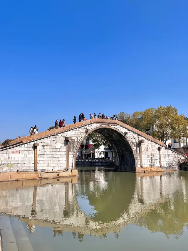 In the ancient town of Zhensze, experience the charm of the Jiangnan water town