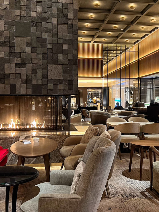 A lobby lounge with a fireplace🥂