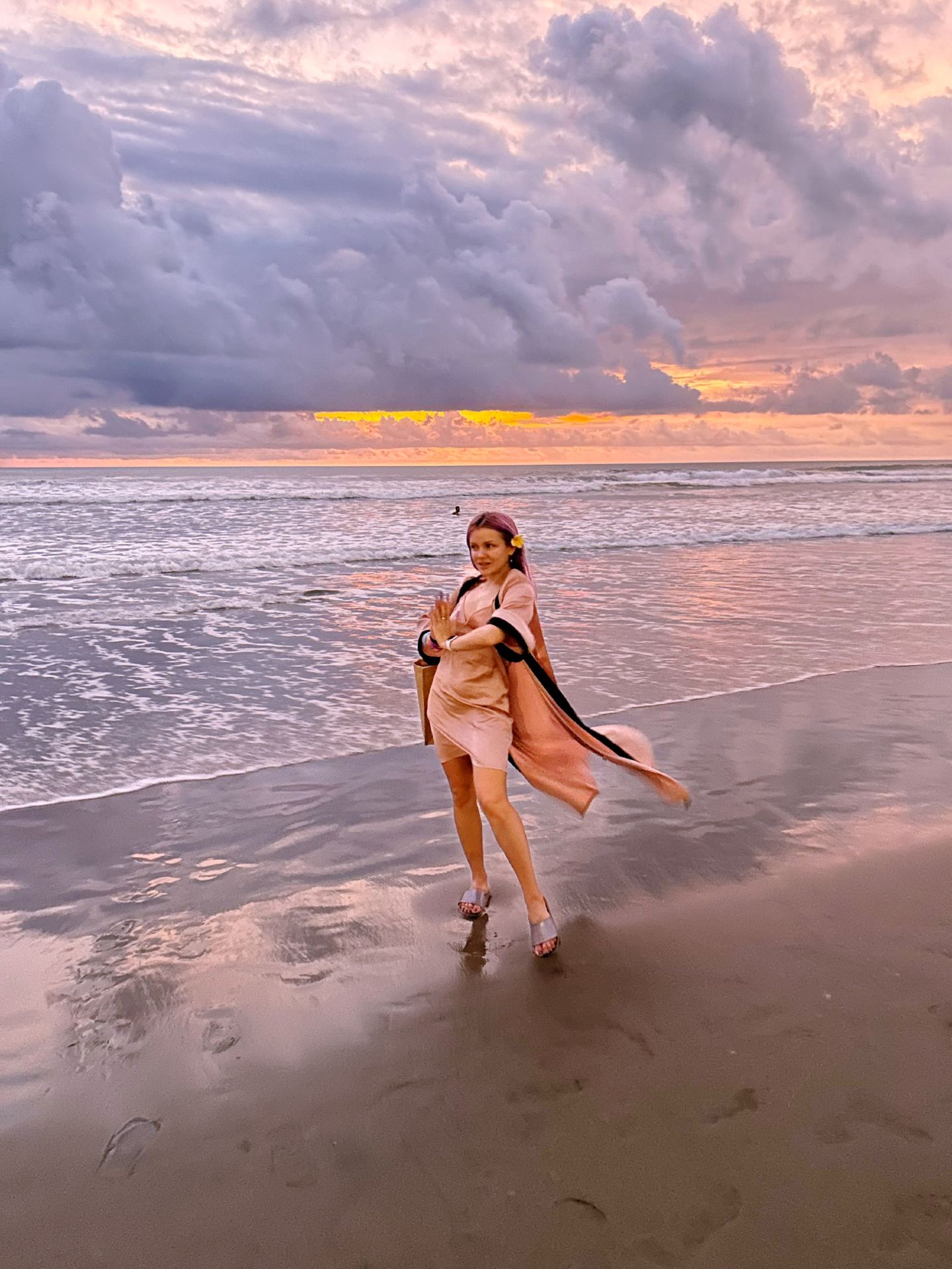 #summerbeachnights 

What could possibly be better than a photoshoot in the golden rays of the setting sun? The light softens, your skin glows, and the camera captures you at your absolute best. But if you look closer, you realize it’s not just a photoshoot. And it’s definitely not just a random natural phenomenon.

To me, the sunset is a live, dramatic performance. It is a theatrical masterpiece that the universe puts on for us every single day. And just like people love dressing up and going to the theater, I walk down to the shore to watch the Theater of the Sunset every single chance I get.

🎬 Act 1: The Exposition & The Opening Scene (The Pink Prelude)Just like a real play, a great sunset has an introduction, a rising action, a climax, and a final resolution.The Curtain Rises: Around 5:45 PM, the sky begins to soften. The harsh daylight fades, and everything around you is painted in gentle, dreamy pastel pink tones. It’s quiet, romantic, and full of anticipation.

🌋 Act 2: The Climax (The Blazing Crimson)This is where the plot thickens. If the day was windy—and the next one promises to be just as wild—the sky starts to load into a heavy, dramatic scarlet.The Transition: The pink dissolves, and the atmosphere thickens into deep, burning shades of crimson and bright scarlet. The clouds catch fire. This is the moment during your photoshoot where the energy completely shifts. It’s powerful, intense, and breathtakingly beautiful.

🌌 Act 3: The Resolution (The Velvet Night)Then comes the final act, the winding down of the grand show.The Finale: The fiery crimson slowly transitions into a rich, heavy mixture of scarlet and jet black. Or, on calmer nights, it morphs into a regal, cosmic violet and deep indigo, slowly melting away into the pitch-black darkness of the tropical night.The curtain falls. The show is over. It is a thrilling, mesmerizing spectacle that leaves you standing on the sand, completely grounded, emotionally recharged, and filled with peace. #hotdiscussion