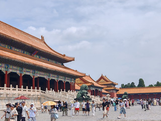 The Forbidden City. I'll be honest - I thought I'd stroll through, take some pretty photos, and leave. Instead I spent the whole day sprinting, squeezing, and getting swept along by crowds like I was in a current.

We got there right at opening and still had to push through the Meridian Gate with about a thousand other people. Everyone moving in the same direction, tour flags waving, somebody's selfie stick nearly taking out my eye. And then you cross that first courtyard, and it's so huge and so empty that the crowd just... spreads out. I broke into a run at one point, just because there was space and because the Hall of Supreme Harmony was up ahead and I wanted to see it before the tour groups caught up. I made it. Stood there, breathing hard, looking up at that double-eaved yellow roof, and the whole thing hit me at once - everything here is built to make you feel small. The yellow tiles were only allowed for the emperor, because yellow was the center of the world, and he was the center of the world. The empty courtyard in front of the hall? Designed to make officials feel tiny before they even got close. I looked back at all those people pouring through the gate behind me and thought, yep, it's still working.

Then I started noticing the details while dodging through the halls. Little rows of animals on the roof corners, each one meaning something, more of them on the more important buildings - the Hall of Supreme Harmony has the most. Bronze turtles and cranes for longevity. Lions out front, the male with a ball under his paw, the female with a cub. I kept stopping to point at things and getting nudged by people behind me, so eventually I just moved with the flow and looked up as I went.

And the best part happened at the back. You cross from the outer court into the inner court, and the scale just drops - smaller halls, tighter courtyards, actual gardens. I ducked into a side passage to escape the crowd and ended up somewhere almost empty, just me and a wall and a tree. That's where I finally slowed down. The emperor as a god out front, the emperor as a person in the back, and I'd run the whole way between them. Six hundred years later, the place still makes you do exactly what it was built to make you do.
#travelersvoice #chinatravelcircle 