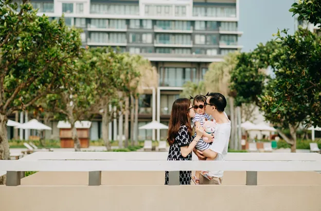 A young family in front of a hotel