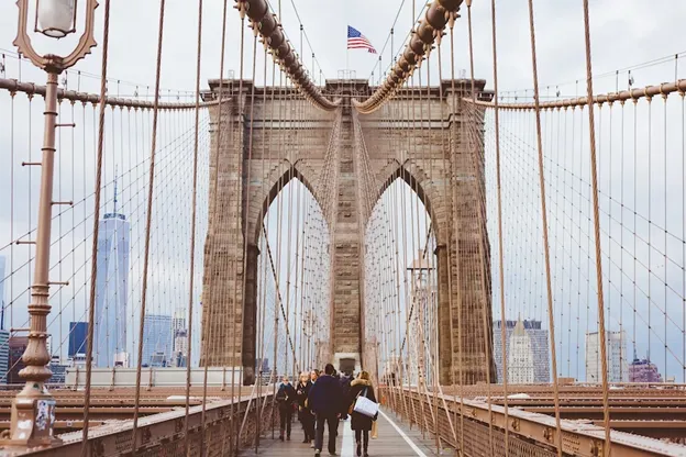 People walking across the Brooklyn Bridge in New York City