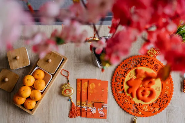 hinese New Year decoration and red envelopes on table