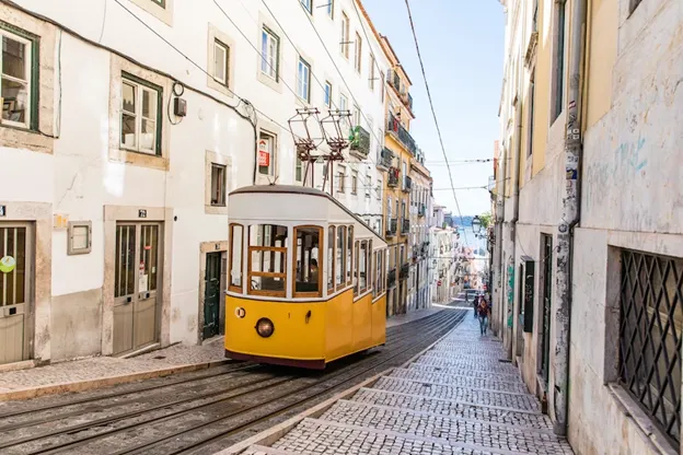 A yellow tram going through Lisbon