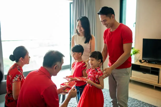 grandparent giving grandchild red pocket during Chinese New Year