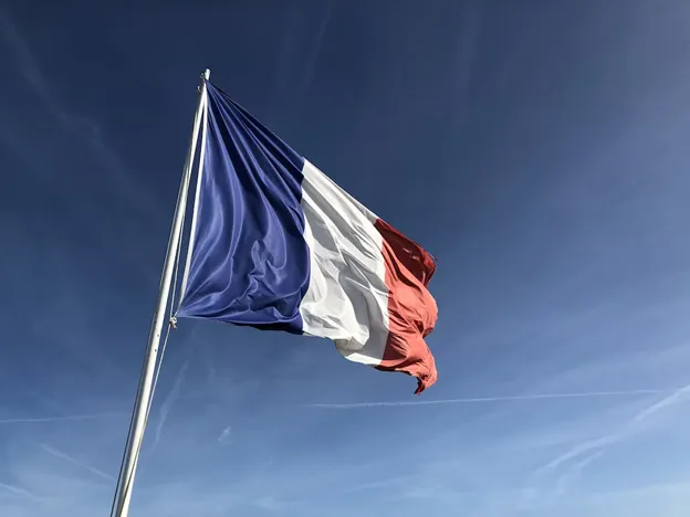 The French flag against the blue sky
