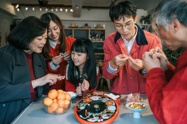 Chinese multi generation family enjoying snacks