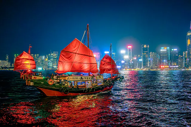 Hong Kong symphony of lights with dukling ship in the view
