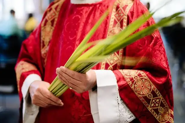 Good Friday 2024 - Priest holding palm leaves for Palm Sunday