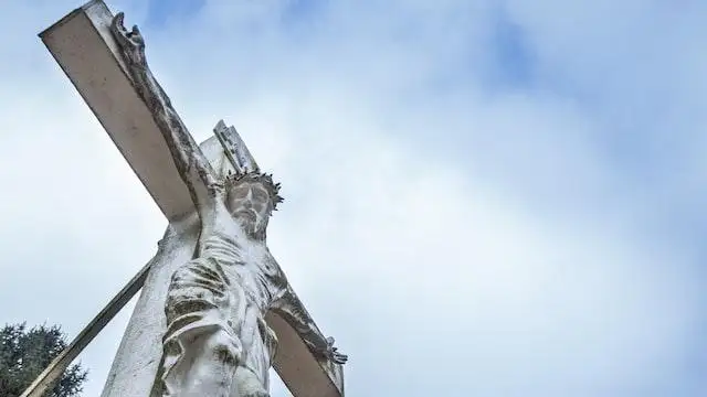 View of a white concrete crucifix from the ground