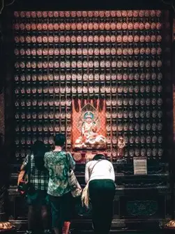 Buddhist devotees pray at an altar in Singapore