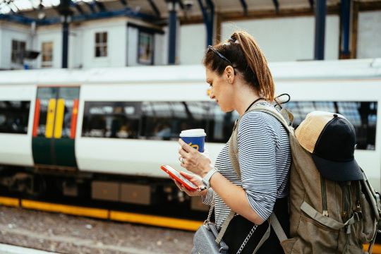 Woman waiting at a UK train station