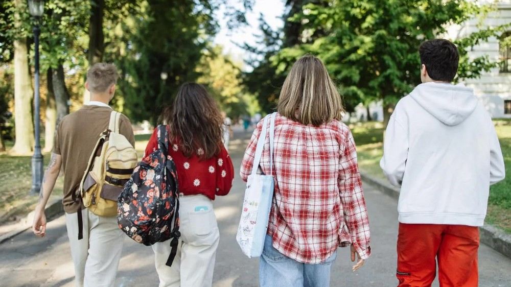 Students walking through a park on their way to university