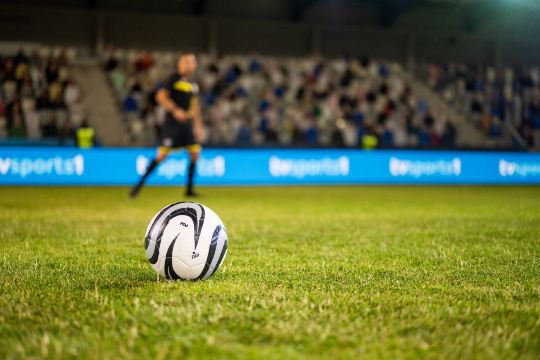 A football on the pitch at Tottenham Hotspur Football Stadium.
