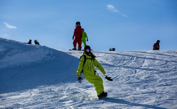 Skiers on a sunny snowy slope