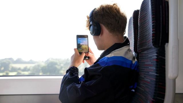 a man on the train taking a phone
