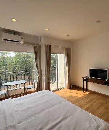 ห้องคิงไซส์โคซี่พร้อมระเบียงและวิวสีเขียว